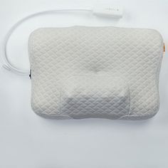 an electric pillow is plugged in to the wall