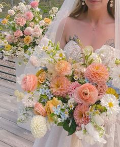 a bride holding a bouquet of flowers on her wedding day