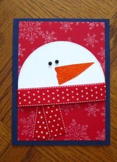 a red and white card with a snowman on it's head, in the shape of a penguin