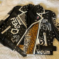 Black Leather Jacket With White Trimming And Some Leopard Print, Studs And Patches. White Punk Leather Jacket With Long Sleeves, White Long Sleeve Punk Leather Jacket, White Fitted Punk Biker Jacket, White Punk Outerwear For Fall, White Punk Style Outerwear For Fall, White Fitted Edgy Outerwear, Graphic Jacket, Graphic Jackets, Black Leather Jacket