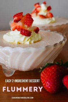 two desserts with strawberries and whipped cream on them