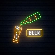 a neon sign that says beer and a bottle with a carrot on it in front of a brick wall