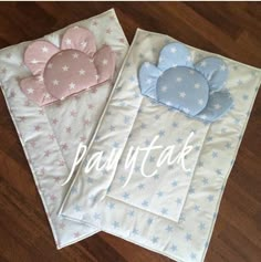 two baby sleeping bags with stars and clouds on them, one is pink and the other is blue