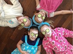 four children with cucumbers on their faces are standing in a circle