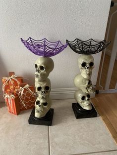 two skulls sitting next to each other with spider webs on top of their heads