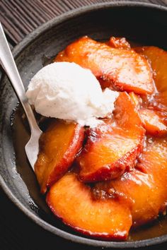 a bowl filled with sliced peaches and ice cream