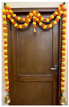 a door decorated with orange and yellow pom poms