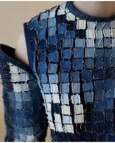 a woman's dress made out of denims and other fabric material with holes in the back