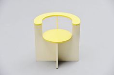 a small yellow table sitting on top of a white stand