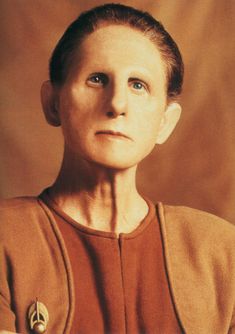 an old photo of a woman with blue eyes and a star trek insignia on her shirt