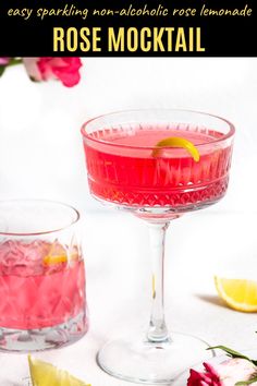 a pink cocktail in a coupe glass with ice and lemon wedges