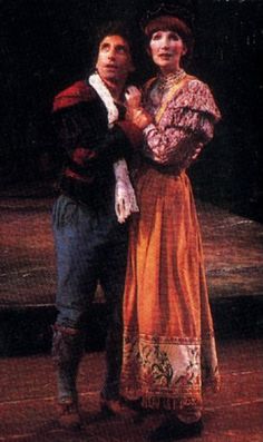 two people standing next to each other on a stage