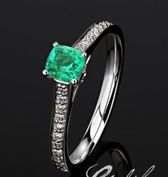 Fine Jewelry Emerald Ring With Cushion Cut Diamond, Green Cushion Cut Diamond Ring For Formal Occasions, Platinum Emerald Ring With Pave Setting As Gift, Diamond Emerald Ring With Cushion Cut And Prong Setting, Formal Cushion Cut Emerald Ring In White Gold, White Gold Emerald Ring Cushion Cut For Formal Occasions, Emerald Diamond Ring With Cushion Cut And Prong Setting, Cushion Cut Emerald Diamond Ring In White Gold, Cushion Cut Emerald Ring For Formal Occasions