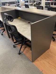 an office cubicle with two desks and chairs