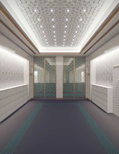 an empty room with several lockers and lights on the ceiling is lit by recessed lighting