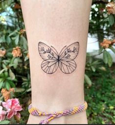 a small butterfly tattoo on the ankle