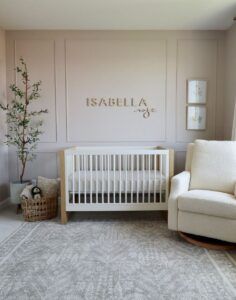 a baby's room with a crib, chair and rug