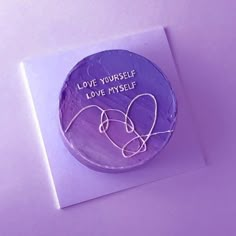 a purple cake with the words love yourself on it