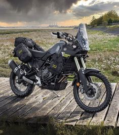 a motorcycle parked on top of a wooden platform