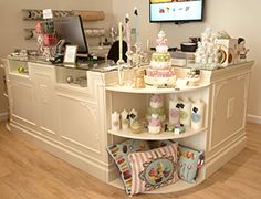 a counter with many items on it and a television in the corner behind it,