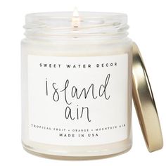 a candle that is inside of a jar with the words island air written on it