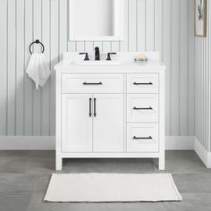 a white bathroom vanity with mirror and towel rack on the wall next to it,