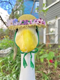 a bird wearing a hat with flowers on it's head