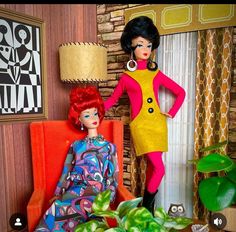 two dolls are sitting in chairs next to a table with plants and potted plants