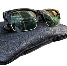 Rare and hard to find vintage Chrome Hearts Mingus A sunglasses. These Chrome Hearts sunglasses are in very good condition and a rare find. Size 54 / 17 and measures 5"6 total width, 1"5 high and 5"6  (temple) long. These sunglasses have detailed frames, fleur de lys logo on under frame with light green lenses with very minor scuffs on lens and on exterior plastic, but are minimal. 100% genuine Chrome Hearts made in Japan and come with leather case and signature cloth/cleaner.  I SHIP WORLDWIDE    I want to stress that item is vintage which means it's not new. All my customers are very important to me and I believe communication is very important. I do not sell or encourage any one to sell fakes.  Not responsible for items lost, damage or packages that may be misdirected which are not insu Vintage Chrome Hearts, Chrome Hearts Sunglasses, Mens Glasses Fashion, Chrome Hearts, Black Sunglasses, Mens Glasses, Glasses Fashion, Eyewear Sunglasses, Leather Case