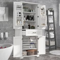 an open cabinet in the bathroom with towels and other items on shelves next to it