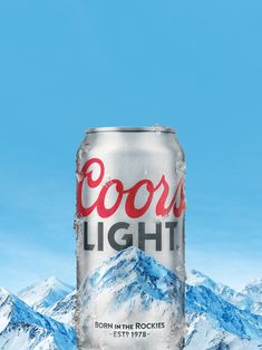 a can of coca - cola in front of mountains with the words cool light written on it