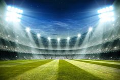 an empty soccer stadium with bright lights