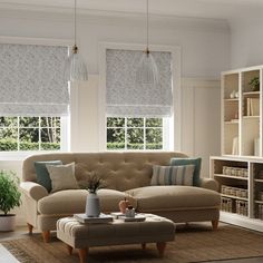 a living room filled with furniture and windows covered in shades of blue, white and green