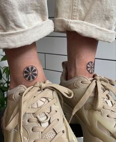 a pair of feet with tattoos on them