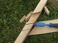 a pair of pliers are laying on the ground next to some wooden planks