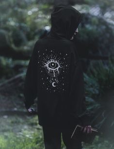 Get 10% off your first order: join.lucidamystica.com Mystical evil eye celestial front and back graphic on a unisex goth hoodie that's soft, warm and cozy for the colder months. Perfect for yourself or as a gift for your favorite witchy human. Plus sizes available for a roomy fit, size up for an oversized aesthetic look. Size chart found in images.  * 50% cotton, 50% polyester  * Double-lined hood * Double-needle stitching throughout  * Air-jet spun yarn with a soft feel and reduced pilling * 1x Gothic Hoodie With Graphic Print, Mystical Clothing, Mystic Clothing, Plus Size Alt, Hoddies Outfits, Goth Hoodie, Eye Hoodie, Oversized Aesthetic, Diy Clothes Design