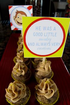 cupcakes with peanut butter frosting and a sign on top that says he was a good little mommy and always very happy