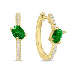 Bring a touch of playfulness to your sophisticated style with these tilted oval green emerald and diamond hoop earrings in 10K gold. Crafted in warm 10K gold Each hoop features a 6.0 x 4.0mm oval-shaped verdant-green emerald glistening at a tilt atop a ribbon of diamonds. Shimmering with 1/5 ct. t.w. of diamonds These earrings secure with hinged backs. 14k Gold Oval Huggie Earrings Fine Jewelry, Fine Jewelry Oval Huggie Earrings With Prong Setting, Yellow Gold Oval Huggie Earrings Fine Jewelry, Elegant Green 14k Gold Huggie Earrings, Green 14k Gold Hoop Earrings Fine Jewelry, Green Diamond Hoop Earrings Fine Jewelry, Green 14k Gold Fine Jewelry Hoop Earrings, Emerald Studs, Verdant Green