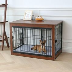 a dog sits in its cage on the floor