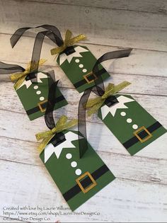 three green paper christmas trees with bows on them