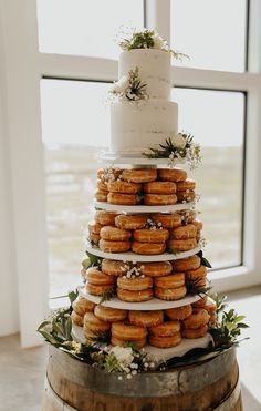 a wedding cake with donuts stacked on top