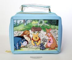 This is a Loungefly Disney Winnie The Pooh and Friends Fall lunchbox style crossbody bag.  This wonderful bag is made with a durable faux leather and features debossed prints of Pooh and his friends in a fall scene.  The front print shows Pooh stuck in Rabbit's borrow, while the back panel scene takes place inside Rabbit's home with Rabbit turning Pooh's bum into wall art...hilarious!  The bag has a zip-around large main compartment, a top carrying handle, a removable and adjustable shoulder str Disney Style Gift Bag, Rectangular Shape, Pooh And His Friends, Lunch Kits, Fall Lunch, Pooh Pictures, Winnie The Pooh And Friends, Winnie The Pooh Pictures, Pooh And Friends, Lunch Kit