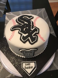 a cake that is sitting on top of a table with the chicago white sox logo