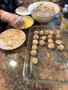 a woman is making some food on the counter top with other dishes in front of her