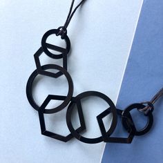 Black mid-century modern geometric acrylic necklace which is stylish and perfect for the woman who likes contemporary style. My necklaces are light and easy to wear and will give your favourite outfit an instant pop of colour. A really unusual and interesting combination of three hexagons and four circles linked together and finished with silky black cord and a silver plated magnetic clasp. It is mid-length and measures 26 inches long and hangs 14 inches from the clasp to the bottom link. The la