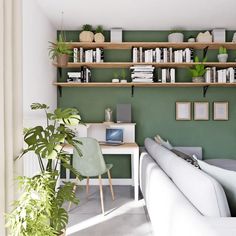 a living room filled with furniture and bookshelves next to a table covered in plants