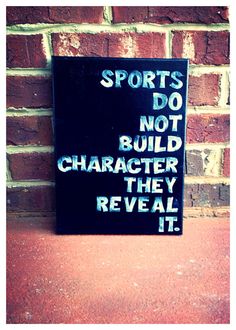 a sign that says sports do not build character they reveal it on a brick wall