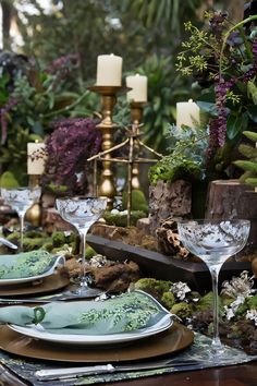 the table is set with green plates and silverware