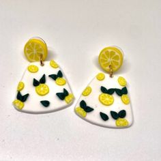 two yellow and white earrings with lemons on them