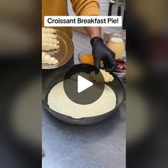 a person is making food in a pan on the counter with words that read, croissant breakfast pie